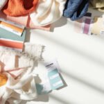 Flat lay of fabric swatches, Pantone chips, and woven brand labels for OEM customization