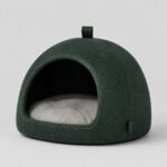 Green fabric cat cave bed with a grey cushion